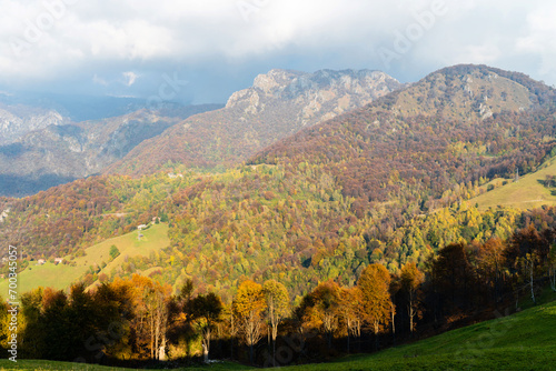 Beautiful landscape of the layered misty hazy Italian Alps mountain range during evening. Alpine summer sunrise. Lombardy, Italy