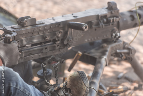 Machine gun mounted on Humvee and person shooting the .50 Caliber.  photo