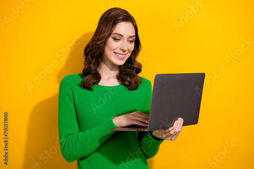 Portrait of gorgeous cheerful person toothy smile use laptop coworking isolated on yellow color background