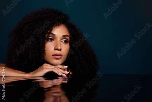 Magazine cover of confident flirty lady beauty model in modern studio with water reflection on glass table