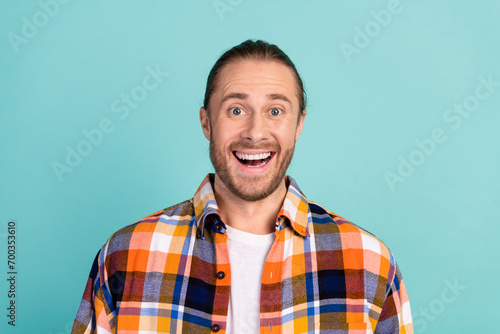 Photo of impressed overjoyed man with beard dressed flannel checkered shirt staring at unbelievable sale isolated on teal color background © deagreez