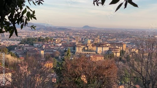 Bergamo Alta, Italy. Aerial view at sunset, seen from San Vigilio in winter season. - Wideangle - Horizontal panning left to right. photo