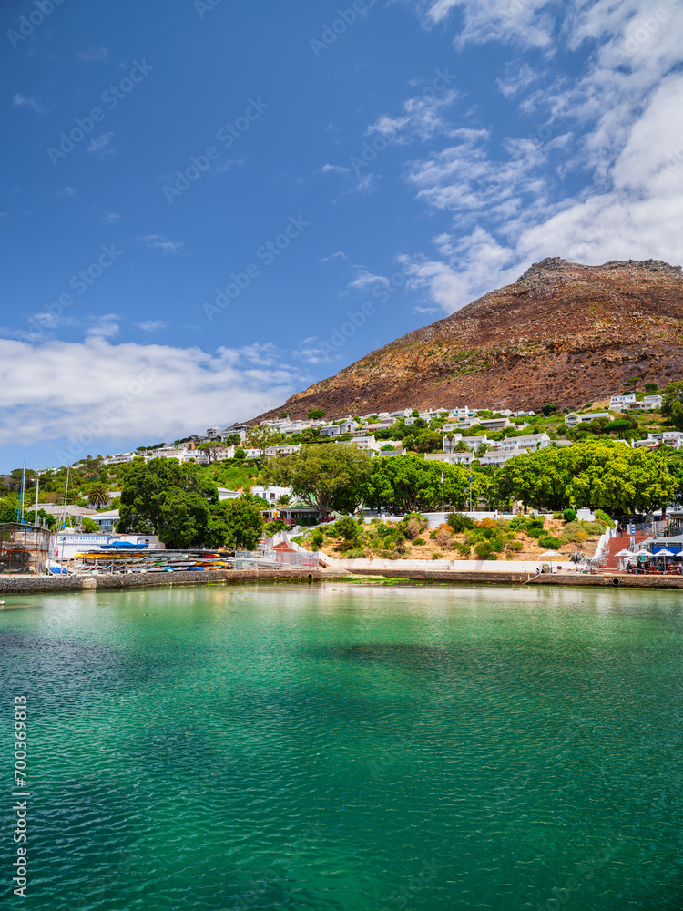 Wide angle shot of Simon's Town Waterfront with turquoise water and town houses on the mountain slopes in the background, peninsula, Cape Town, South Africa