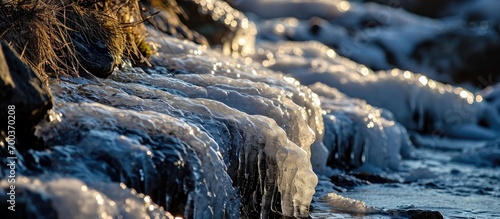 Winter's chill forms ice on rocky surfaces.