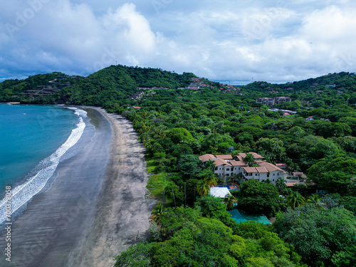 Aerial view of a small coastal village in Costa Rica capturing the Pacific Ocean, rainforest and architecture. 