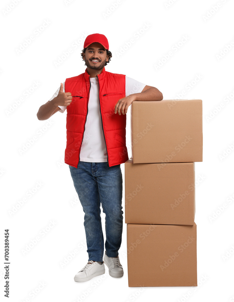 Happy courier with stack of parcels showing thumb up on white background Happy courier with stack of parcels showing thumb up on white background
