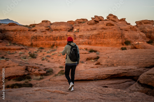 Portrait Person With Bright Red Beanie in St George, Utah Dixie Rock wearing Backpack Outside Sunset Golden Hour Red Rocks photo
