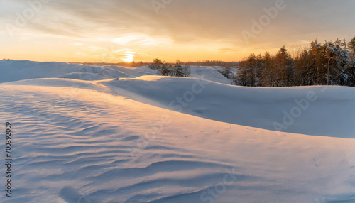landscape with undulating snowdrifts under serene blue sky, evoking tranquility and seasonal beauty