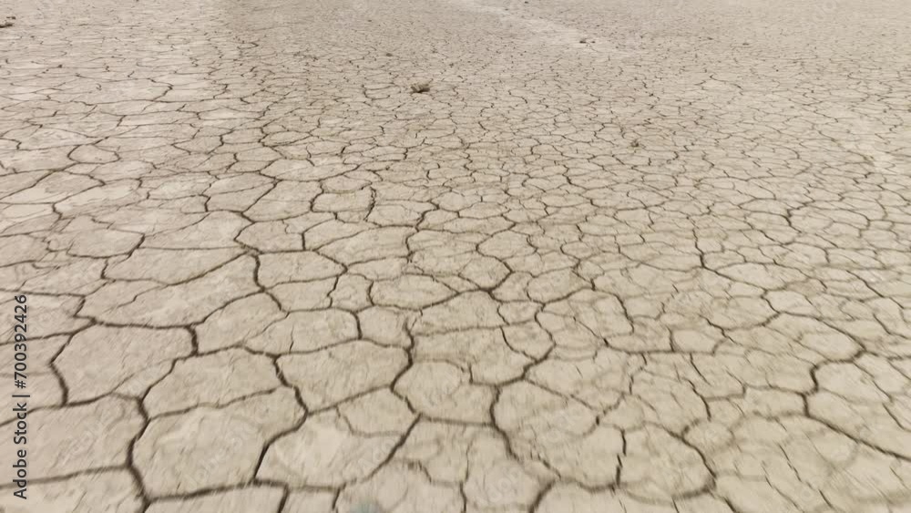 Aerial shot looking down at the cracked surface of a dry lake. Aerial shot looking down at the cracked surface of a dry lake.