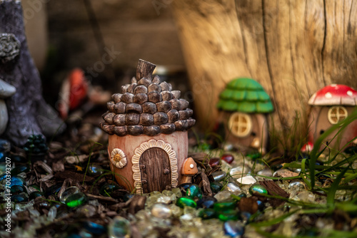 Billede på lærred Cutest Little Fairy Hut In Gem Decorated Rock Garden Macro Photo