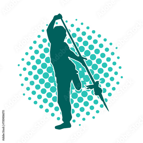 Silhouette of a martial art person in action pose with spear weapon. Silhouette of a fighter male using spear weapon in battle pose.