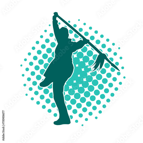 Silhouette of a martial art person in action pose with spear weapon. Silhouette of a fighter male using spear weapon in battle pose.