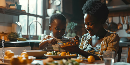 African American happy mother and his son eating healthy food at home photo