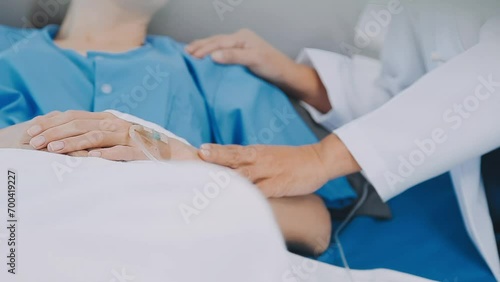 Asian female doctor giving hope and encourage to stressed woman patient at hospital. Smiling doctor woman touching on patient shoulder to support take care and helping . Supported and Encouraged photo