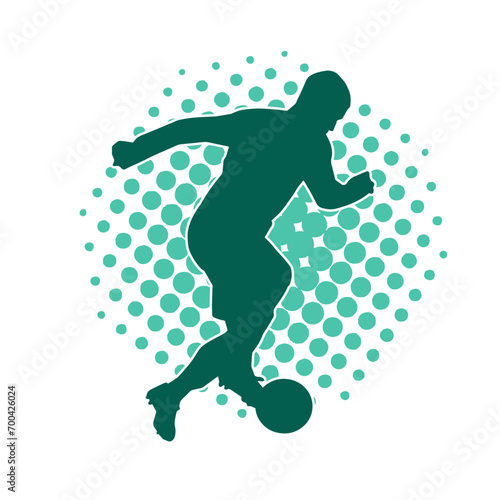 Silhouette of a male soccer player kicking a ball. Silhouette of a football player in action pose.