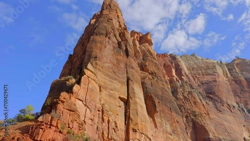 Establishing shot of mountains with red rocks in Temple of Sinawava, Zion National Park, Utah, North America. Day time. ProRes 422 HQ. photo