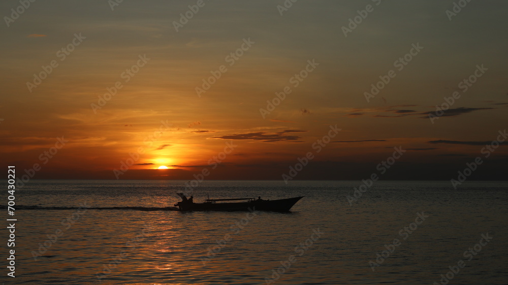 Silhouette of a Boat on the Sea at Sunset