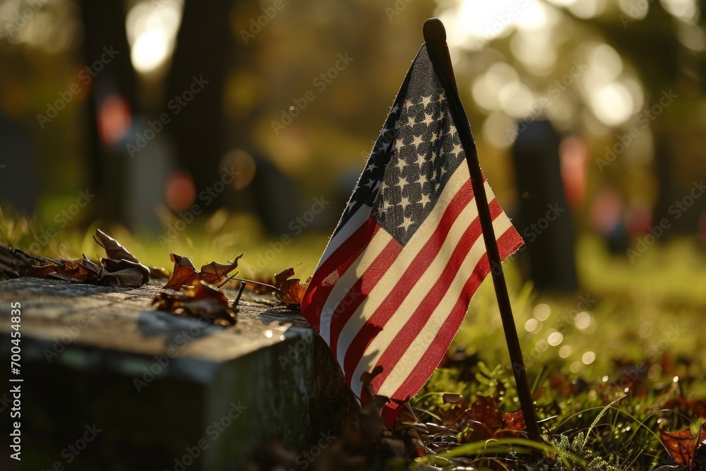 American flag laid on a grave in a cemetery. Suitable for patriotic and ...