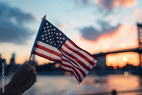 Image generated with AI. a hand holding a flag of the United States with New York out of focus in the background