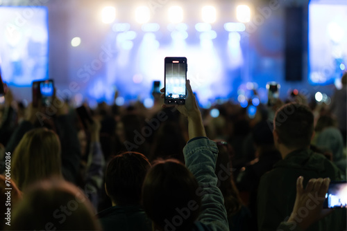 Silhouette of hands using camera phone to take pictures and videos at live concert, smartphone records live music festival, Take photo in front concert stage, happy youth, luxury party.