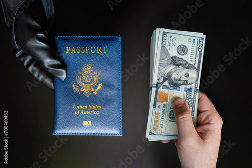 Hands holding passport USA and us dollar bills. passport issuance. Forgery of documents, a criminal concept, black market of American passports