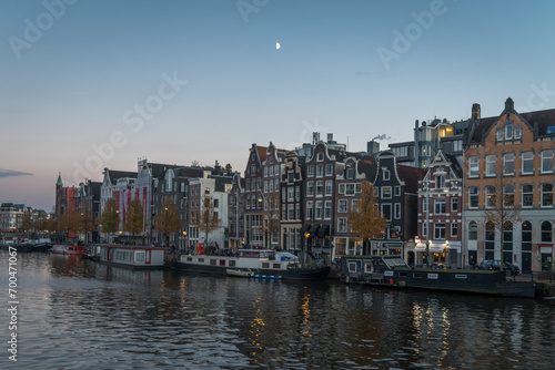 Morning half moon over Amsterdam canal and houses