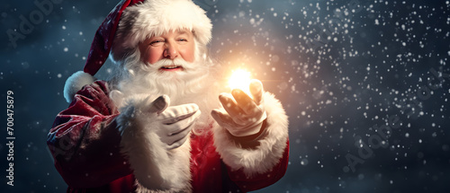 Smiling Santa Claus offering a magic light in his hands © katobonsai