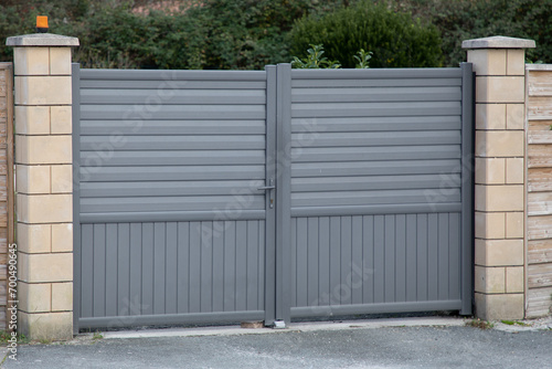 high gray gate double door steel big grey metal entrance portal fence on modern house street