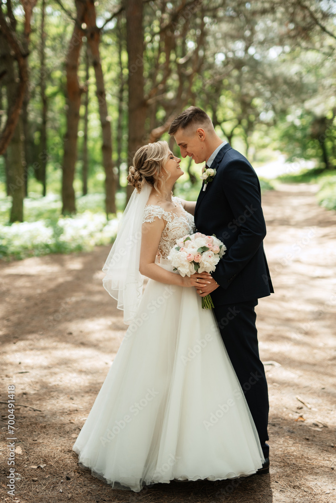 the groom and the bride are walking in the forest the groom and the bride are walking in the forest