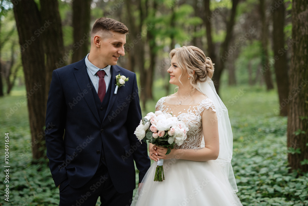 the groom and the bride are walking in the forest the groom and the bride are walking in the forest