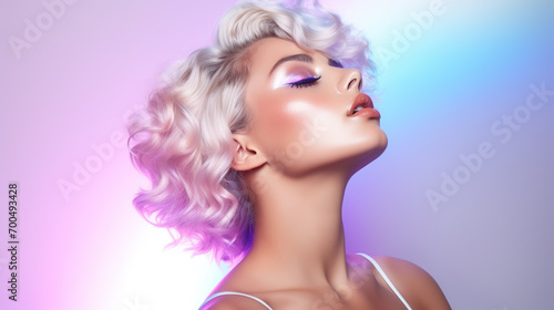 Elegant blonde woman with glamorous make-up against pink backdrop.