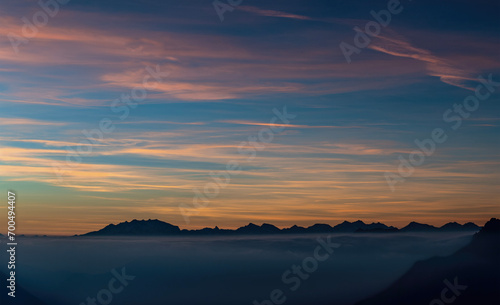 Sunset over the clouds with Monte Rosa massif on the horizon photo