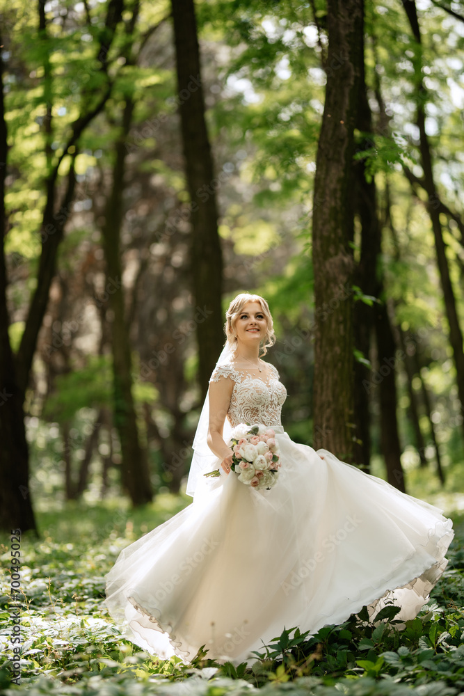 young girl bride in a white dress in a spring forest