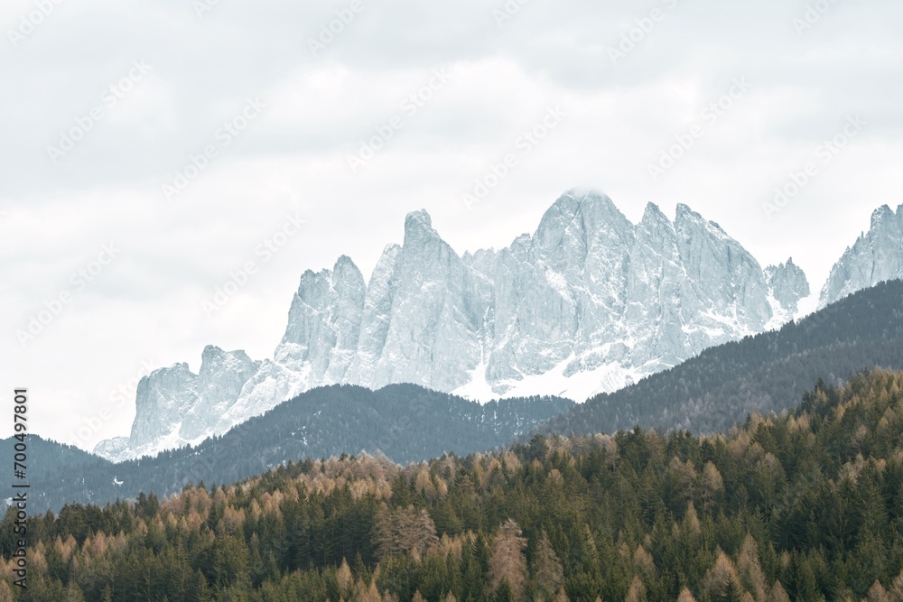 Springtime in the Italian Alps with the sun setting over the Dolomites peaks. Panoramic view of idyllic mountain scenery in the Alps on a beautiful day. Destination traveling.