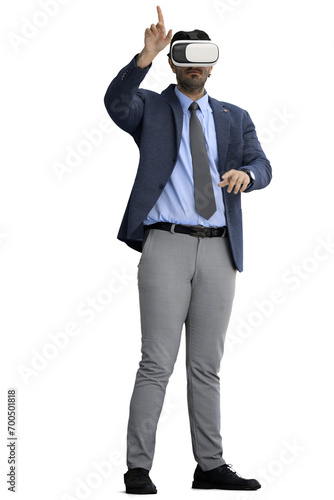 A man in an office suit on a White background listens to music on headphones