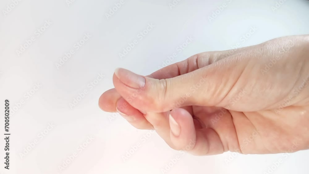 Fingers Snapping in Front of White Background. The woman clicks her hand with natural nude nails. Close-up view Fingers Snapping in Front of White Background. The woman clicks her hand with natural nude nails. Close-up view