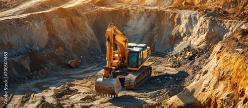 A large yellow wheeled excavator is working in a quarry Heavy construction hydraulic equipment excavation Rental of construction equipment Development of minerals. Creative Banner. Copyspace image photo