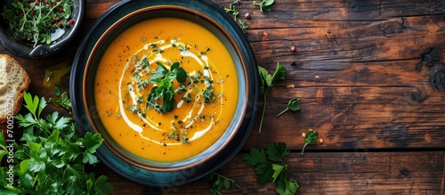 Curried carrot soup with cream and fresh herbs. Creative Banner. Copyspace image