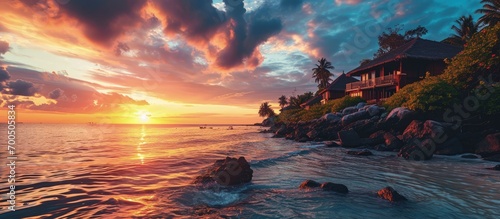 Amazing sunset landscape Picturesque summer sunset in Maldives Luxury resort villas seascape with soft led lights under colorful sky Dream sunset over tropical sea fantastic nature scenery