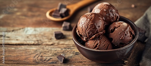 Homemade artisanal chocolate ice cream on a wooden table with spoon and chocolate truffles. Creative Banner. Copyspace image