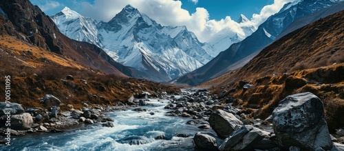 Himalaya mountains and stream water from melted glacier view from Bimthang village in Manaslu circuit trekking route in Nepal Asia. Creative Banner. Copyspace image photo