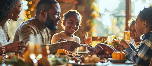 Happy black parents and kids toasting while celebrating Thanksgiving day during family lunch at dining table. Creative Banner. Copyspace image