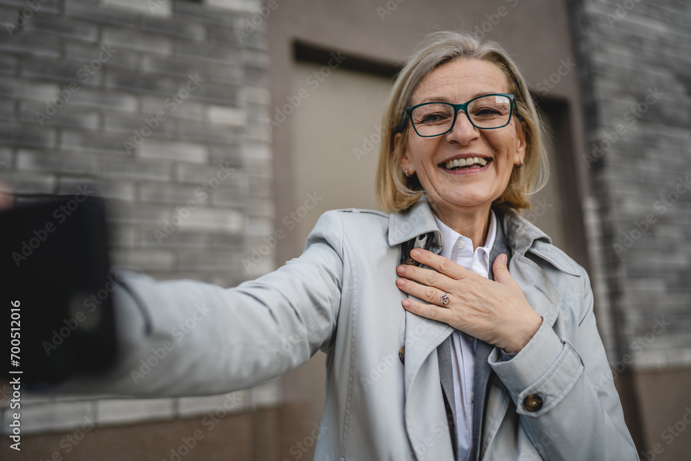 One mature woman outdoors take photos or video call with mobile phone One mature woman outdoors take photos or video call with mobile phone