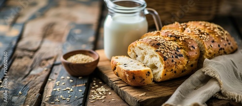 Breakfast with freshly baked sesame bread and milk Whole grain bread on a wooden board Gluten free bread Copy space. Creative Banner. Copyspace image