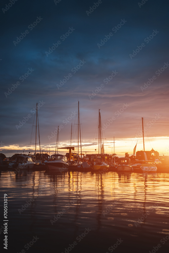 port with luxury yachts and ships and sunny blue sky at sunset or sunrise