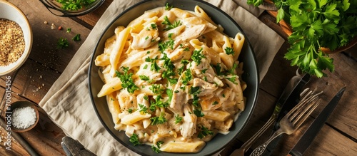 Homemade Chicken Alfredo Penne with Parsley on cloth top view Overhead from above flat lay. Creative Banner. Copyspace image