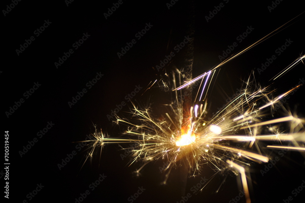 Golden sparkler on black. Bright sparklers on black background closeup