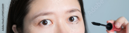 woman made a mistake when using mascara and it smeared on her eyelids
