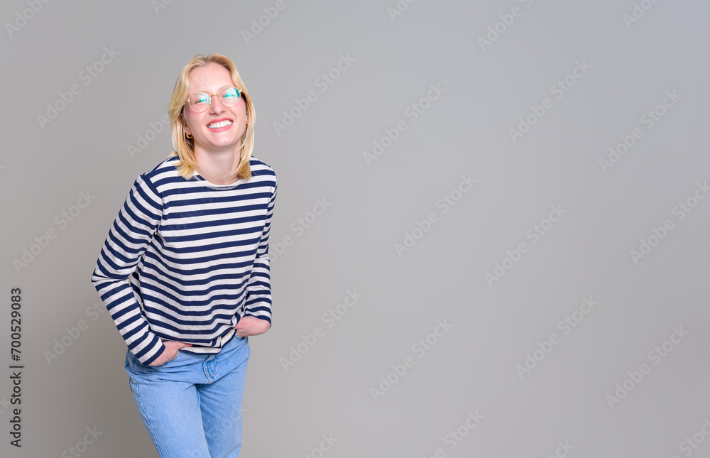 Portrait of cheerful young businesswoman with hands in pockets smiling against white background Portrait of cheerful young businesswoman with hands in pockets smiling against white background