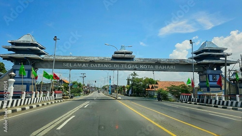 Tegal, Indonesia - January, 2024 : welcome gate of Tegal regency, with blue sky as background photo
